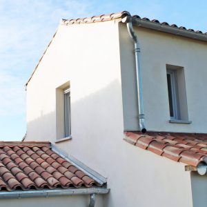 Toiture en tuiles canal ou romane, gouttière en zinc gris